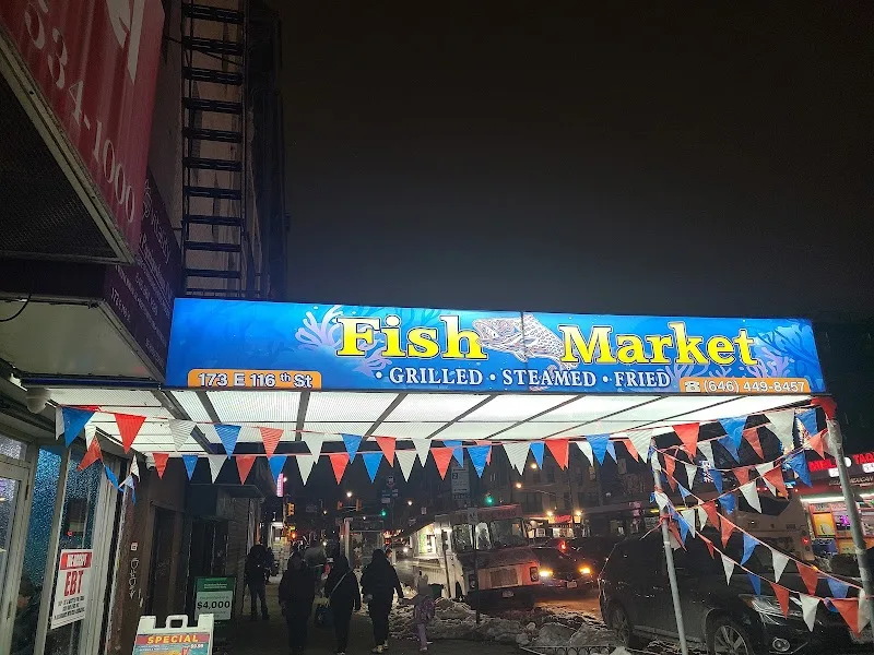 Golden Catch Fish Market lit storefront sign 173 E 116th St East Harlem NYC at night