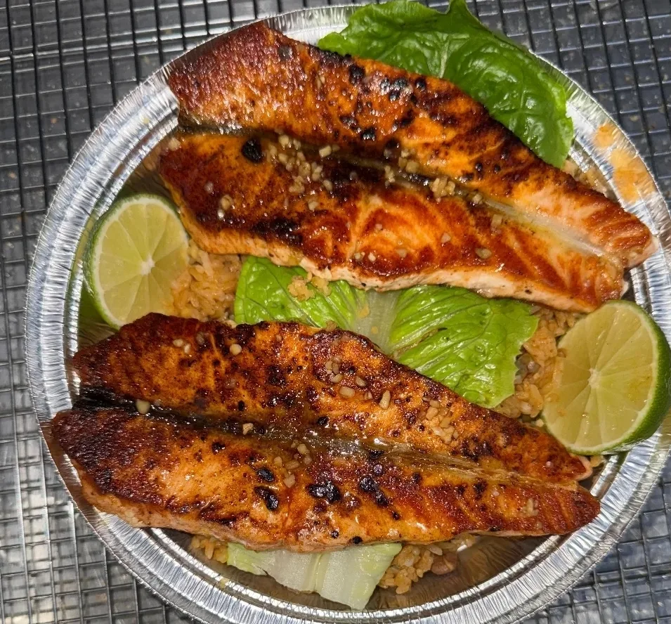 Honey-garlic glazed grilled salmon over rice at Golden Catch Fish Market Harlem