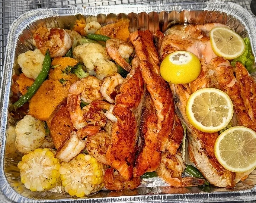 Grilled salmon and jumbo shrimp with sweet potato and cauliflower at Golden Catch Fish Market Harlem
